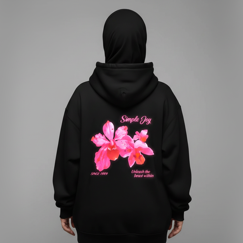 Black hoodie with pink floral design and text on the back against a gray background