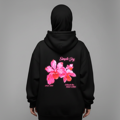 Black hoodie with pink floral design and text on the back against a gray background